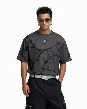 Man wearing a black graphic t-shirt and black pants on a white background